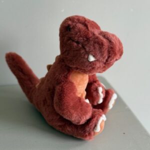 Knuffel zittende Dino